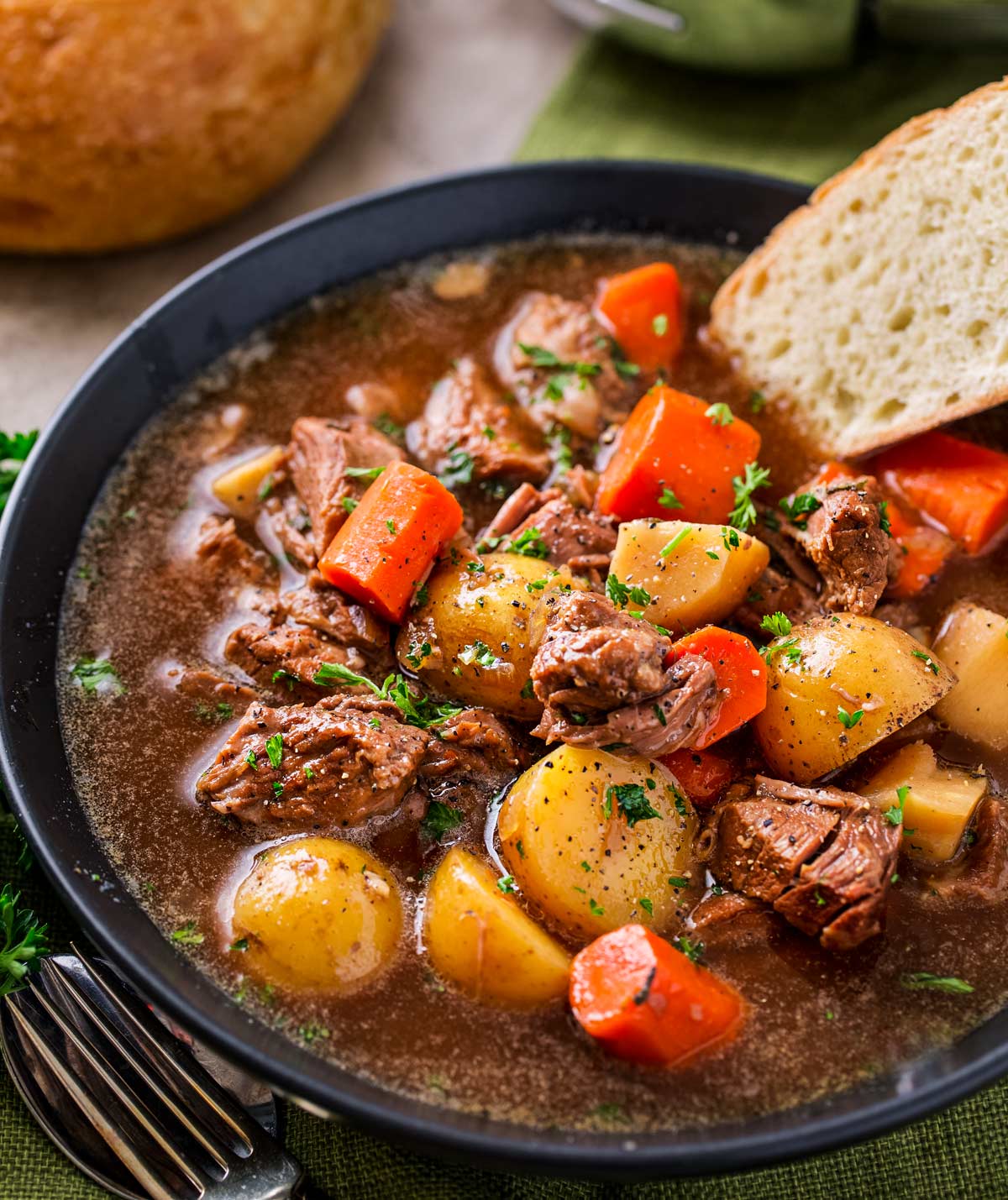 Crockpot Beef Stew with beer and horseradish in a bowl with bread