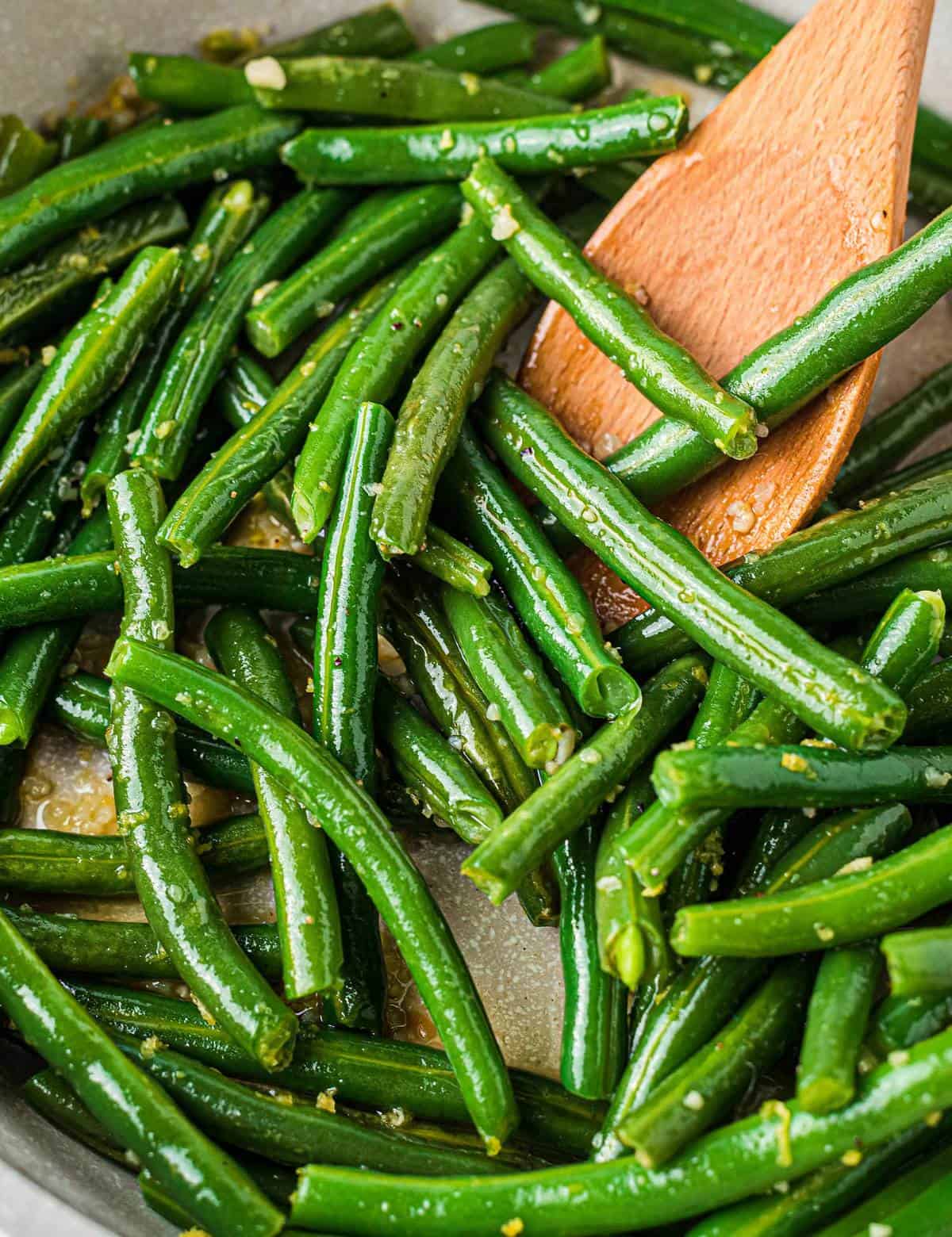 Simple and easy, this Skillet Green Beans recipe is made using fresh green beans that are cooked until crisp tender, and seasoned with plenty of garlic and lemon flavors! They're the perfect side dish! #greenbeans #fresh #sidedish