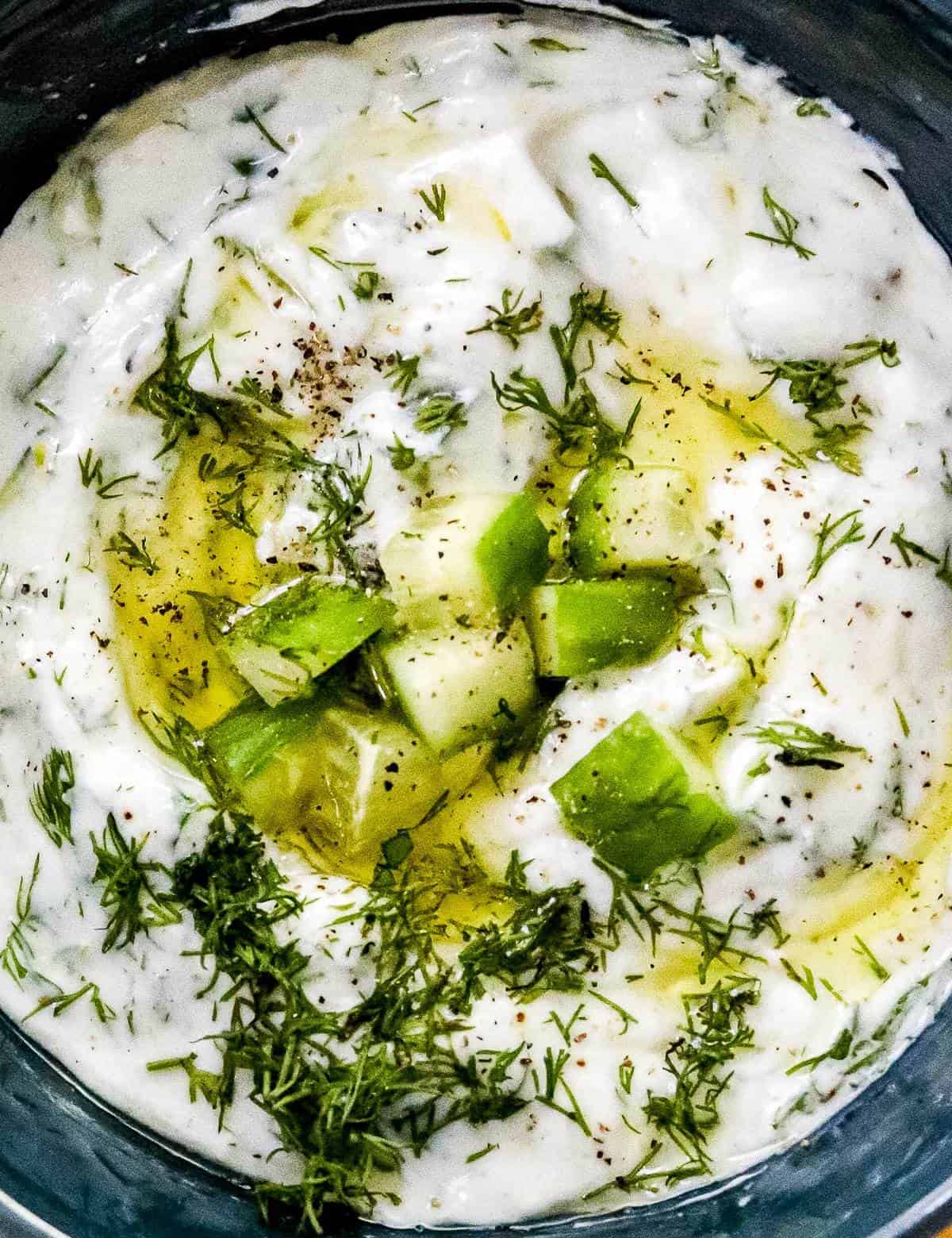 This cool and creamy Homemade Tzatziki Sauce is perfect on all kinds of grilled meats, but also with spiced toasted pita wedges and crunchy fresh vegetables! #tzatziki #greek #sauce #yogurt