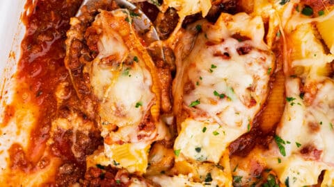 Al dente pasta shells are stuffed with a cheesy ricotta, spinach and garlic filling, then smothered in a hearty meat sauce and mozzarella cheese, then baked until bubbly and golden brown! Perfect for a big family dinner and as a freezer-meal!