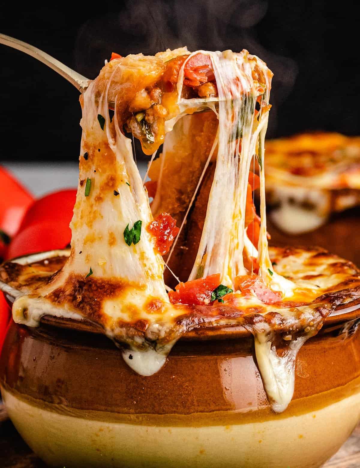 This Deluxe Pizza Soup is brimming with all the flavors of a classic and cheesy deluxe or supreme pizza, but in comforting soup form! Perfect for a weeknight meal, it can be served as a regular soup, or topped with crostini and cheese and baked until gooey and melted (like French onion soup).