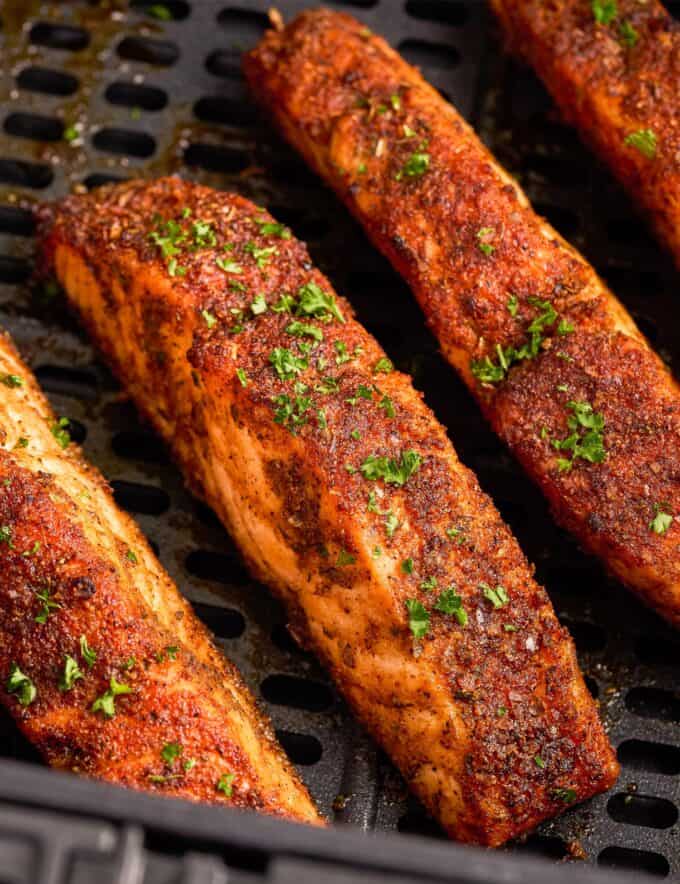 This Air Fryer Cajun Salmon is light and flaky, and ready in less than 30 minutes. Fresh salmon filets are brushed with olive oil, then rubbed with a mouthwatering homemade cajun spice rub. It’s the perfect quick and easy weeknight dinner!