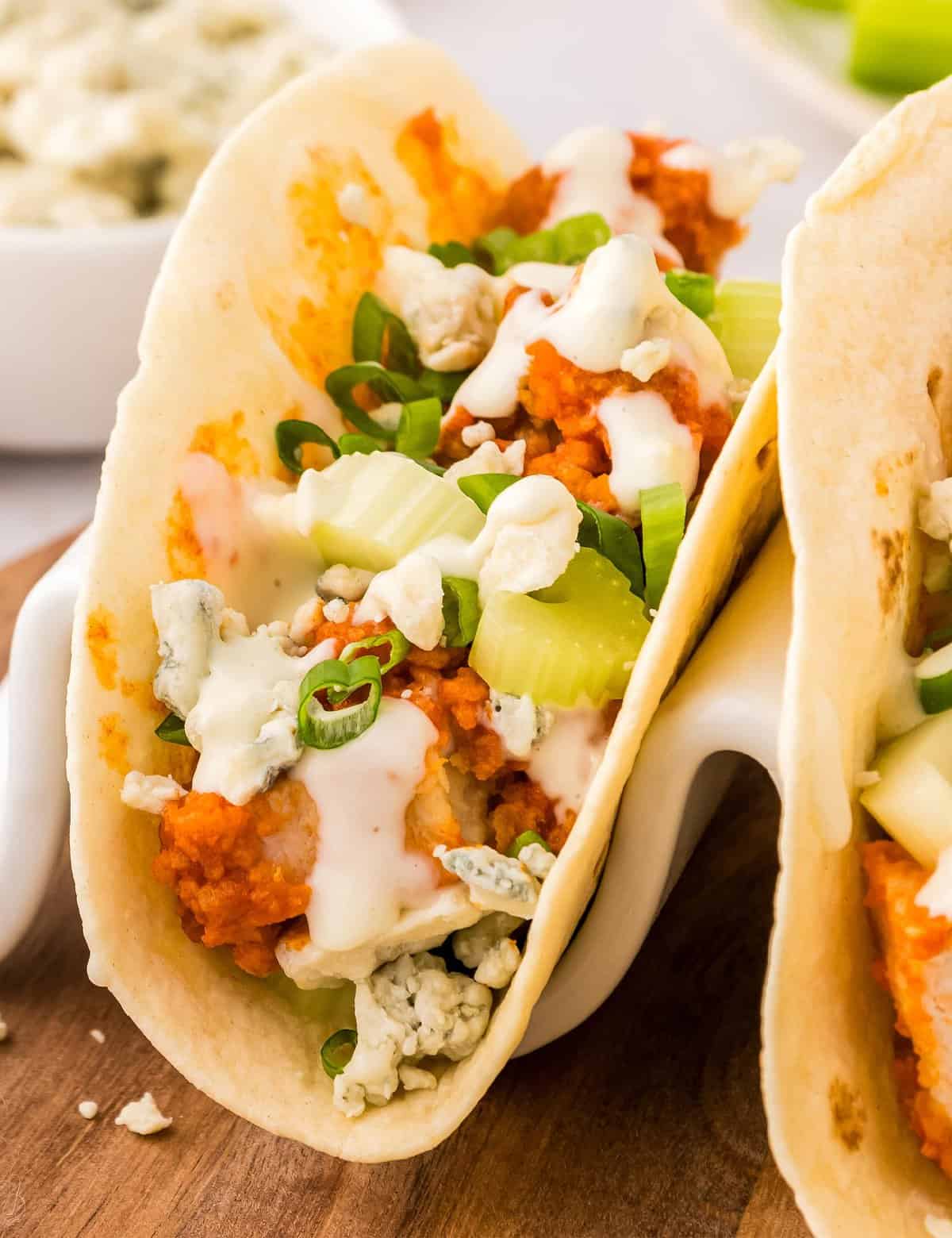 These buffalo chicken tacos are a great semi-homemade dinner or appetizer idea. Frozen chicken tenders make these super easy to get on the table, and fast!