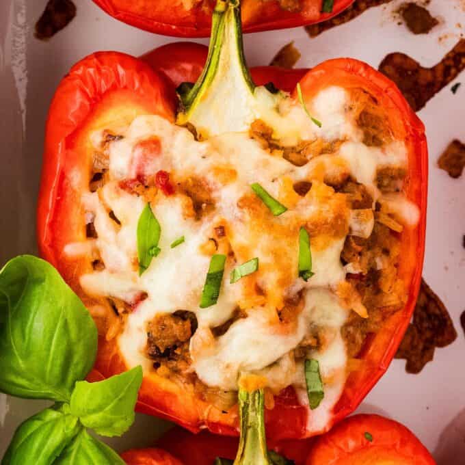 close up photo of stuffed pepper with melted cheese on top.