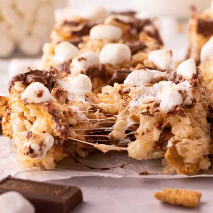 s'mores rice krispie treat pulled apart to show the gooey marshmallows.