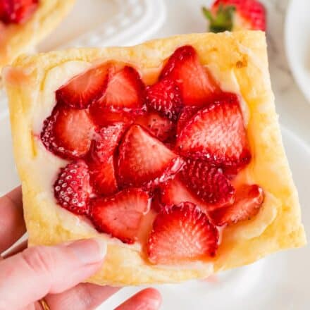 hand holding a strawberry cream cheese danish