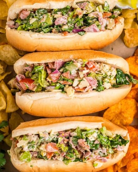 A fresh and delicious chopped salad, complete with several meats, cheeses, and vegetables, tossed with a zippy creamy Italian dressing, and served in soft hoagie rolls. Such a fun way to enjoy a salad!