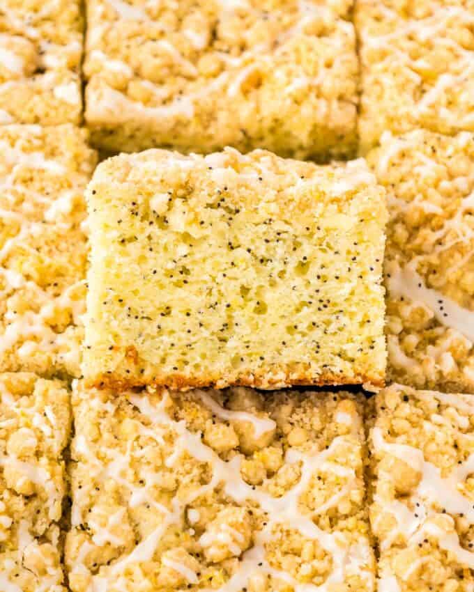 coffee cake with lemon poppyseed flavor, with one slice showing the inside.