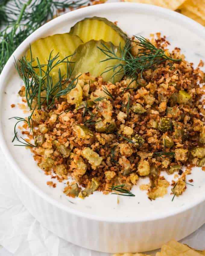 white bowl of fried pickle dip topped with fried breadcrumbs.