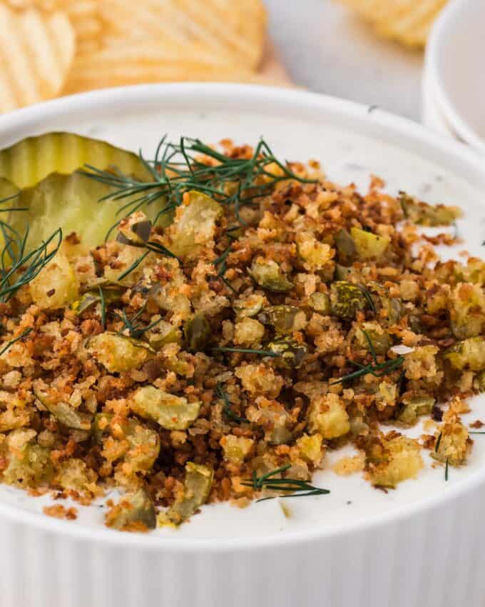 close up photo of the crispy breadcrumb and pickle topping of fried pickle dip.