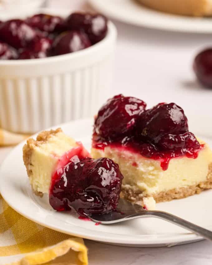 cherry pie filling on a slice of cheesecake.