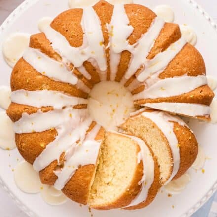 overhead photo of a lemon bundt cake with a few slices cut.