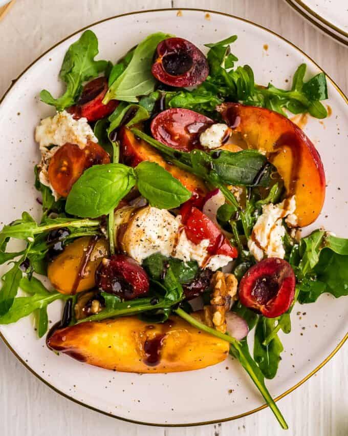 peach burrata salad on a white plate