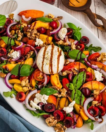 This summer peach burrata salad is great for using all of the amazing fresh produce that's in season, and is such a flavor explosion! The creaminess of the fresh burrata cheese combines effortlessly with the peaches, cherries, tomatoes, onions and more, and the sweet and tart balsamic glaze is the perfect dressing. Great for a light lunch or dinner!