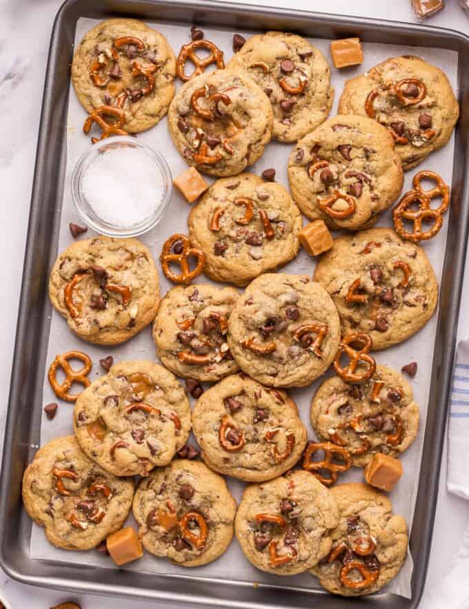 These bakery-style kitchen sink cookies are soft and chewy, and oh so delicious! Made with two types of chocolate, gooey caramel, crunchy pretzels, and flaky sea salt, they're perfect for cookie exchanges, dessert trays, or a fun afternoon treat.