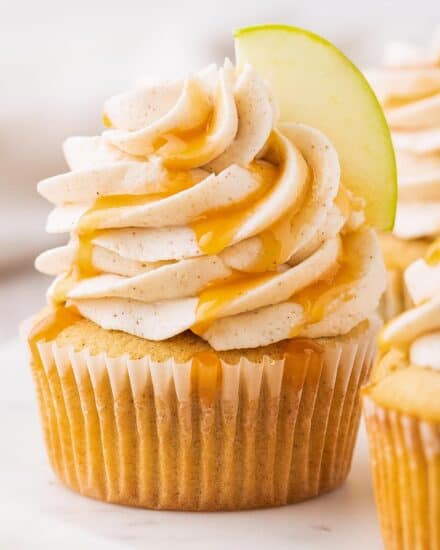 These caramel apple cupcakes are the perfect blend of fluffy, soft, and moist. Studded with diced apples and topped with a generous swirl of caramel cinnamon buttercream frosting, they taste like a sweet caramel apple, and are perfect for the Fall season!