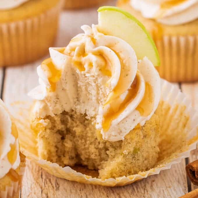 caramel apple cupcake with a bite taken out of it.