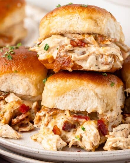 These baked chicken bacon ranch sliders are made with soft slider buns, shredded chicken tossed in a savory ranch sauce with sharp cheese and crispy bacon, then topped with a garlic butter sauce! They’re the perfect appetizer for game day or any party, and will feed a crowd!