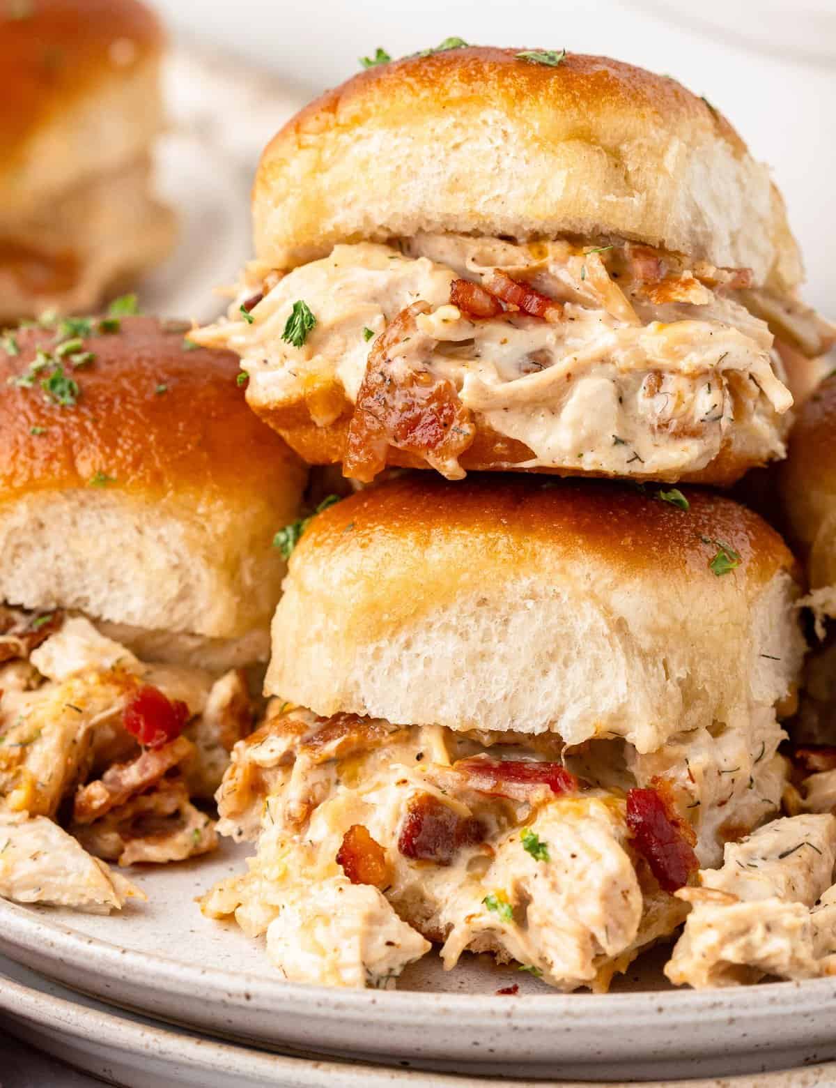 These baked chicken bacon ranch sliders are made with soft slider buns, shredded chicken tossed in a savory ranch sauce with sharp cheese and crispy bacon, then topped with a garlic butter sauce! They’re the perfect appetizer for game day or any party, and will feed a crowd!