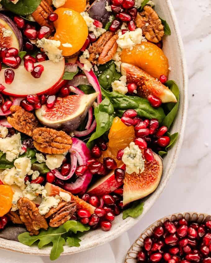 This autumn harvest salad uses plenty of in-season produce, and is great as a side or even a light dinner! The light apple cider orange vinaigrette perfectly elevates the flavors of sharp blue cheese, crisp apples, sweet figs, pickled red onion, candied pecans and more.