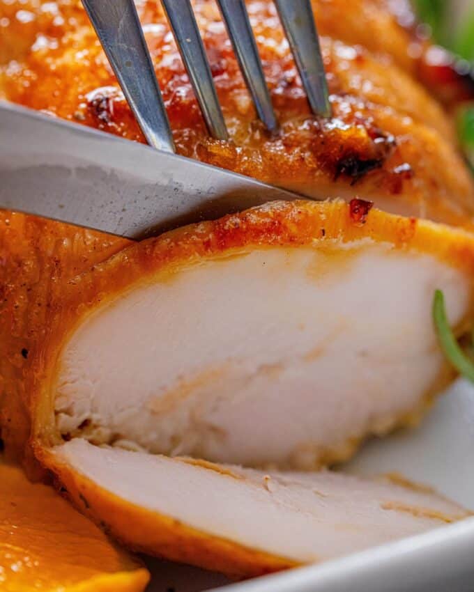 slicing a roasted turkey breast