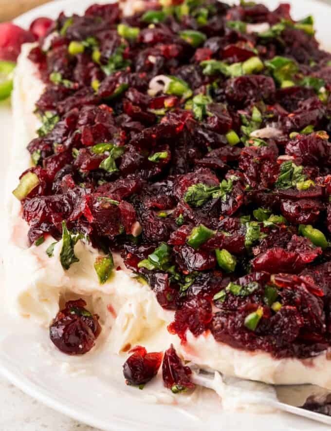 Whipped slightly sweetened cream cheese topped with a sweet, tart, and spicy cranberry jalapeño mixture. The red and green colors are perfect for the holidays, and this recipe uses dried cranberries to make this easy to make year-round. This is a dip that people go crazy over!