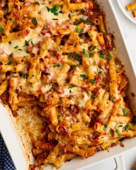 This baked ziti recipe is loaded with sausage and cheesy deliciousness! Perfect as a freezer meal or a big family dinner, this baked pasta dish is made with al dente pasta, a marinara meat sauce, and plenty of mozzarella and pecorino romano cheese!