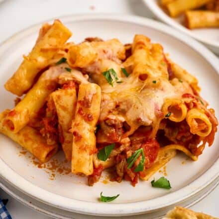 serving of baked ziti with sausage on white plate