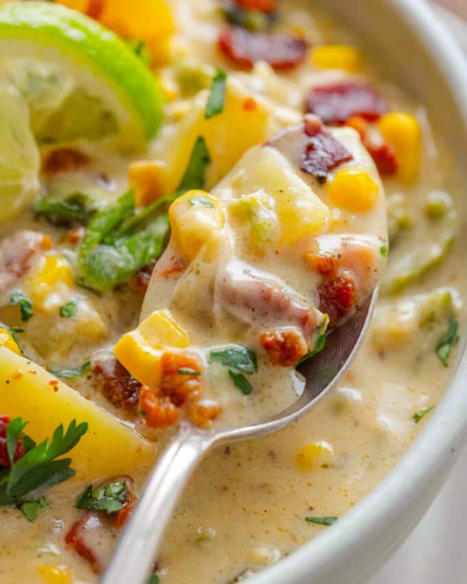 spoonful of corn chowder with poblano peppers