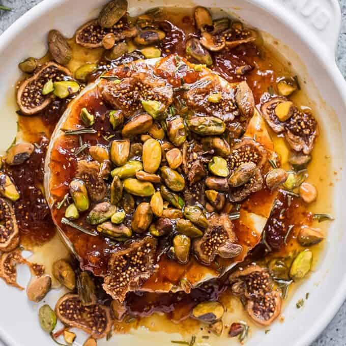 baked brie with fig jam in a white baking dish