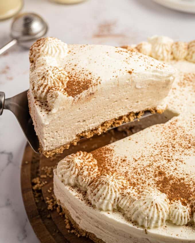 cake server with a slice of eggnog cheesecake on it.