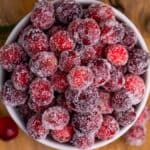 overhead photo of sugared cranberries in a white ramekin