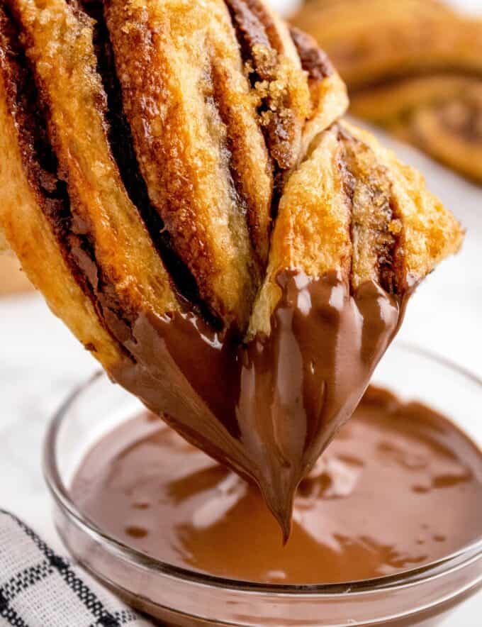 This incredibly easy shortcut version of a flaky pastry swirled with chocolate hazelnut spread is sinfully delicious right out of the oven! Store-bought canned dough makes this recipe accessible to bakers of all confidence levels, and they’re a perfect weekend breakfast or brunch treat!