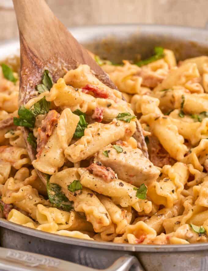 This Marry Me Chicken Pasta is a quick and easy meal that’s sure to be a family favorite! Juicy chicken, a creamy sauce made with bursts of sun dried tomatoes, Parmesan cheese, and spinach, and it’s all ready in about 40 minutes, making it a great weeknight dinner option.