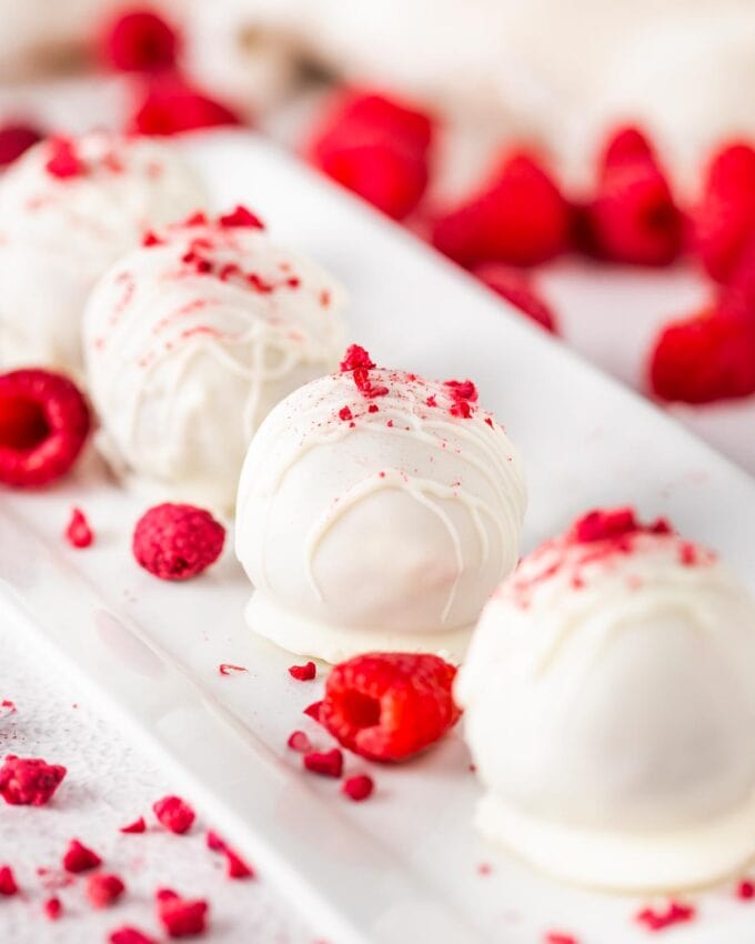 line of cake balls made with raspberries and white chocolate