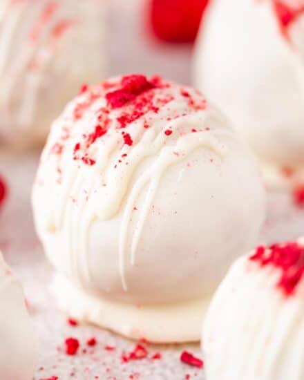 These raspberry white chocolate cake balls are full of sweet raspberry flavor, coated in a white chocolate coating, and sprinkled with crushed freeze-dried raspberries! Perfect for an easy no-bake treat, these are just like cake pops (just without the stick), and a favorite among people of all ages!