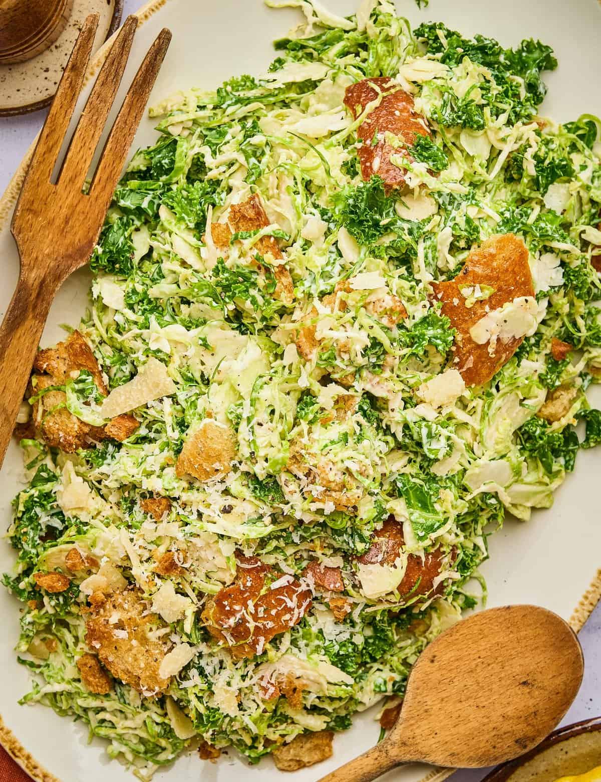 This twist on a classic caesar salad is made with finely chopped kale, shaved brussels sprouts, and easy homemade croutons! You can make this even easier by using store-bought dressing or make your own, and you can add some grilled chicken, salmon, or shrimp for a complete meal!