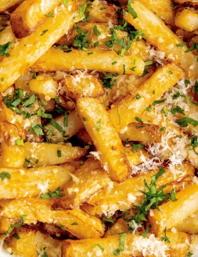 These homemade french fries are crispy on the outside and fluffy on the inside, and positively loaded with bold, savory, garlic parmesan flavors! Easy to make, and easy to customize, you can have this side dish with no guilt.