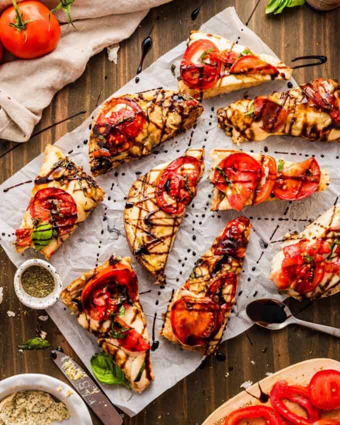 slices of caprese garlic bread  on parchment paper