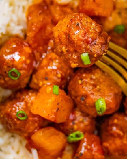 These Spicy Hawaiian Crockpot Meatballs are made easily with frozen meatballs and cooked low and slow in a mouthwatering sweet and savory sauce made from just 5 ingredients (plus salt and pepper)! Perfect as a party appetizer, game day treat, or fun dinner!