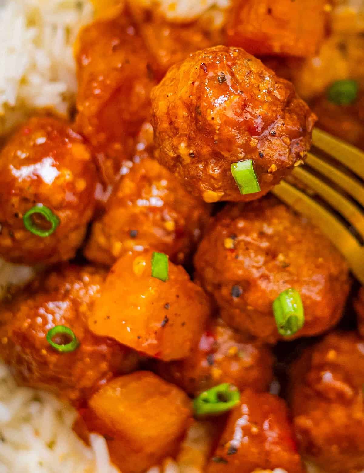 These Spicy Hawaiian Crockpot Meatballs are made easily with frozen meatballs and cooked low and slow in a mouthwatering sweet and savory sauce made from just 5 ingredients (plus salt and pepper)! Perfect as a party appetizer, game day treat, or fun dinner!