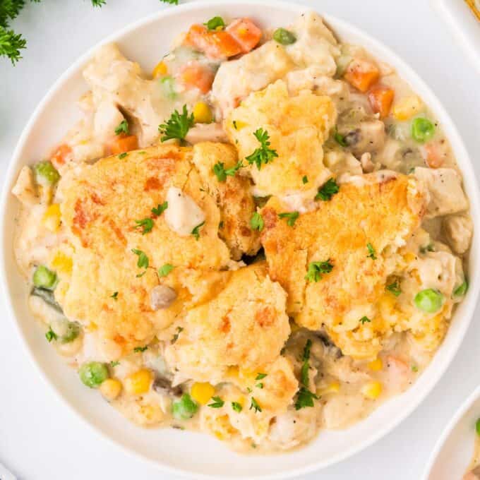 overhead photo of chicken cobbler in a shallow white bowl