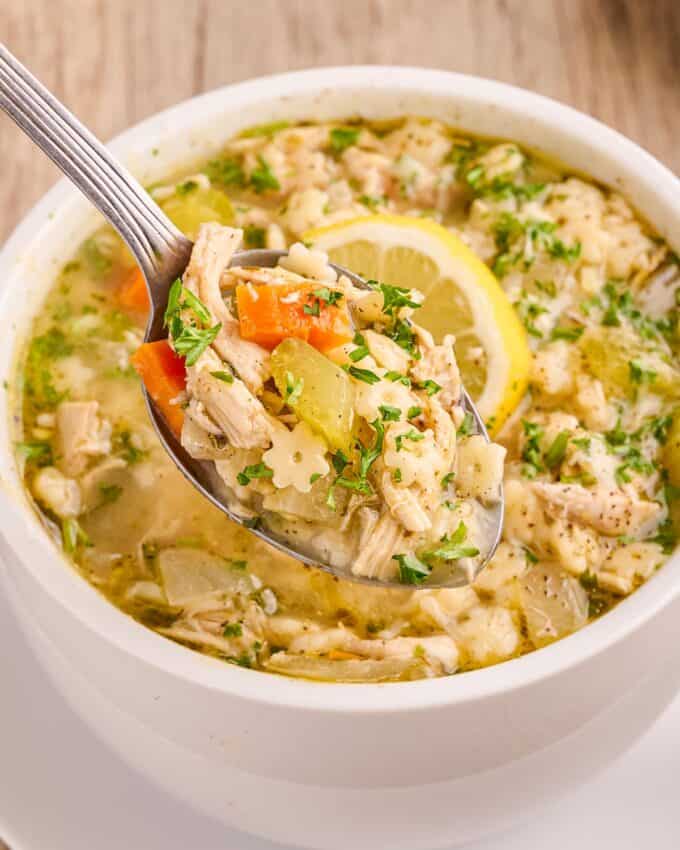 spoonful of chicken and stars soup with parsley