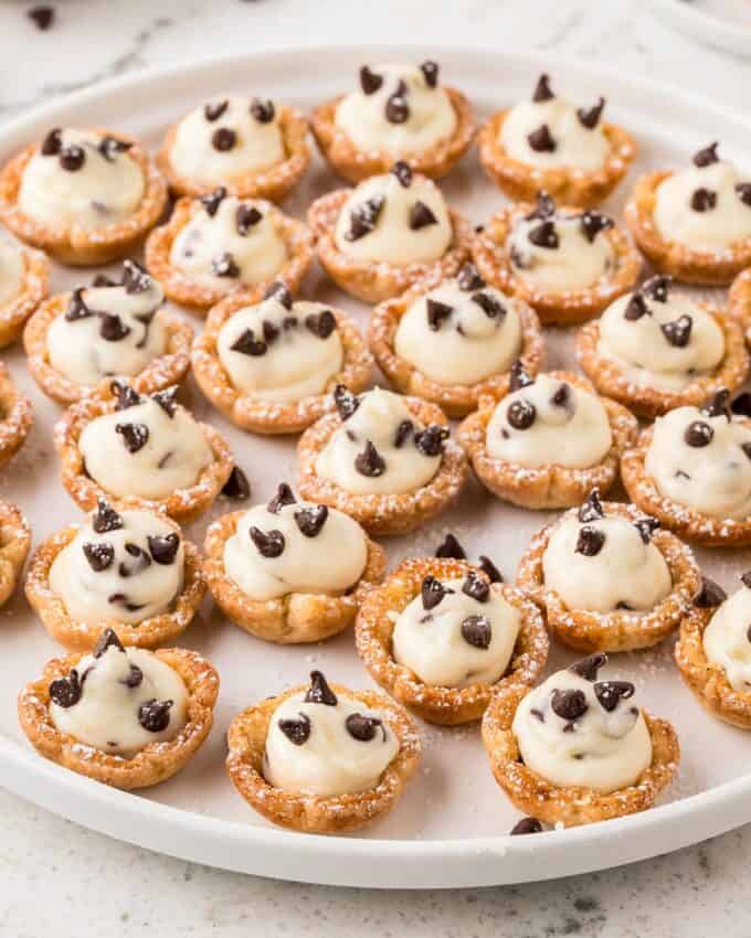 mini cannoli cups on a white platter for serving.